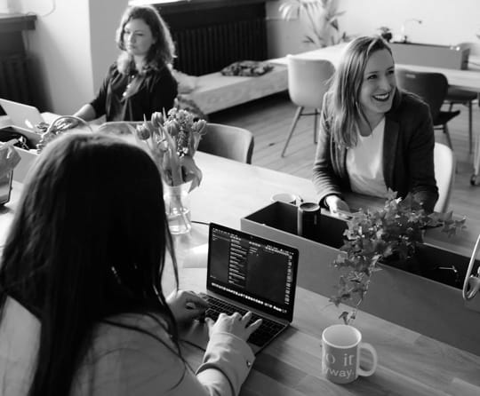 There is a picture of 3 woman are working in a office