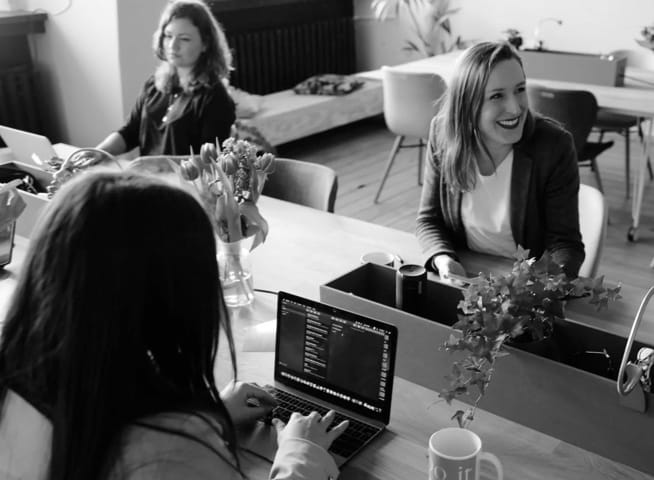 There is a picture of 3 woman are working in a office